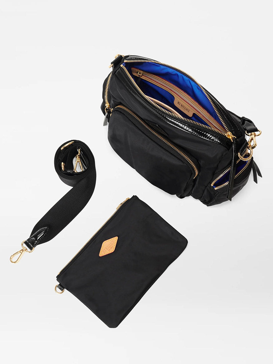 A black diaper bag with a zipper and an adjustable crossbody strap, MZ Wallace Small Chelsea Crossbody in Black Bedford and quilted nylon wallet.