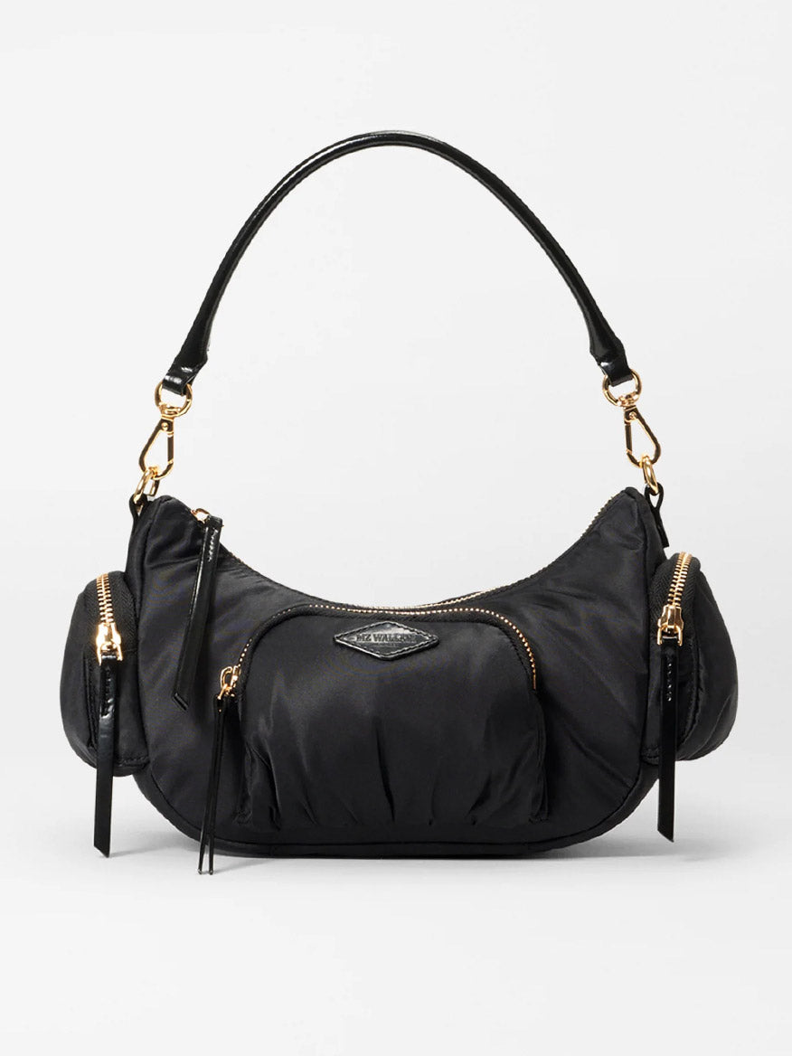 The MZ Wallace Small Chelsea Shoulder in Black Bedford features a curved design, Italian leather, gold hardware accents, a top handle, multiple zippered compartments, and a central logo.