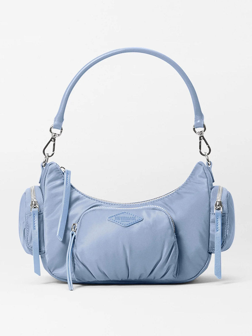 The MZ Wallace Small Chelsea Shoulder bag in Stone Blue Bedford is crafted from Italian leather and features multiple zippered compartments, exterior pockets, and an adjustable strap.