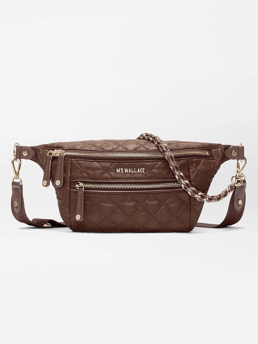 MZ Wallace Small Crosby Sling Bag in Walnut Oxford, a brown quilted recycled nylon sling bag with gold hardware, a zippered front pocket, and an adjustable chain-link strap.