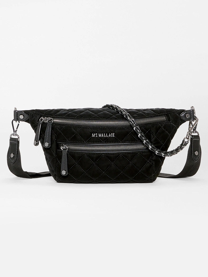 MZ Wallace Small Crosby Sling Bag in black quilted velvet, featuring two zippered front pockets and a chain-link strap.