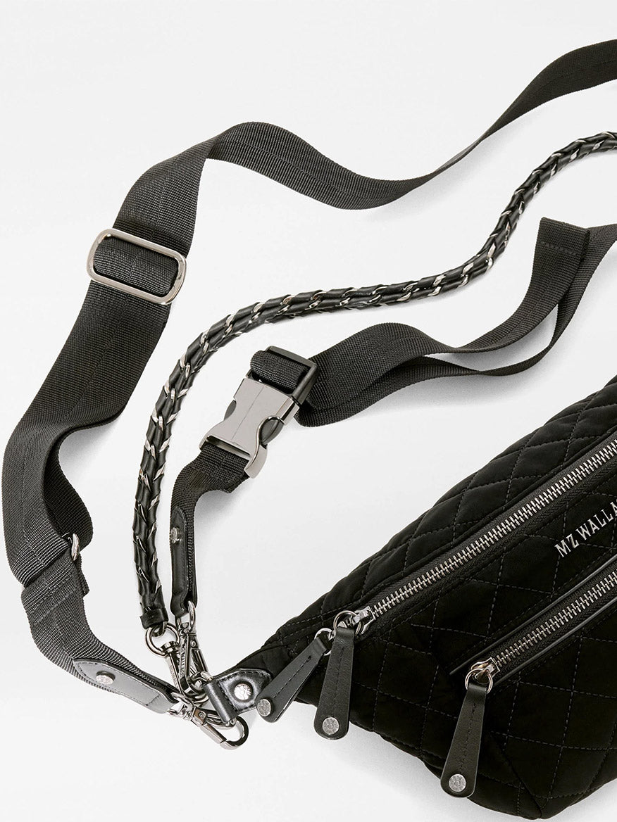 MZ Wallace Small Crosby Sling Bag in black quilted Italian leather with an adjustable webbing strap and a decorative chain handle.