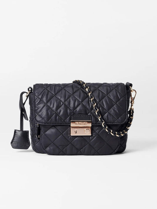 The MZ Wallace Crosby Lock Small Crossbody in Black Oxford features a quilted design with a gold chain strap and clasp, complemented by a small attached pouch on the side. Crafted with Italian leather trim, it offers both elegance and versatility.