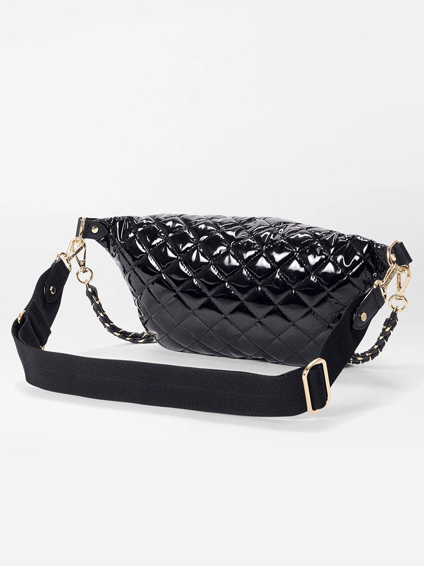 The MZ Wallace Small Crosby Sling Bag in Black Lacquer Oxford features a glossy quilted finish, adjustable black strap, and gold-tone hardware, shown against a plain white background.