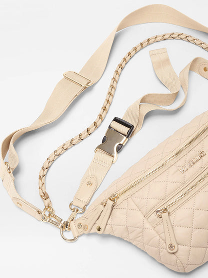 MZ Wallace Small Crosby Sling Bag in Buff Oxford features gold zippers, hardware, an adjustable woven strap, and decorative braided detail.