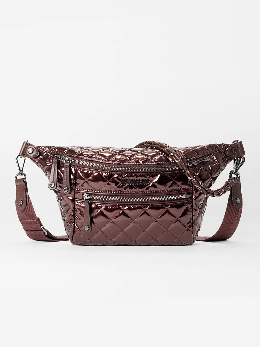 The MZ Wallace Small Crosby Sling Bag in Bordeaux Lacquer Oxford is a quilted metallic crossbody with zippered compartments and an adjustable strap, shown against a plain white background.