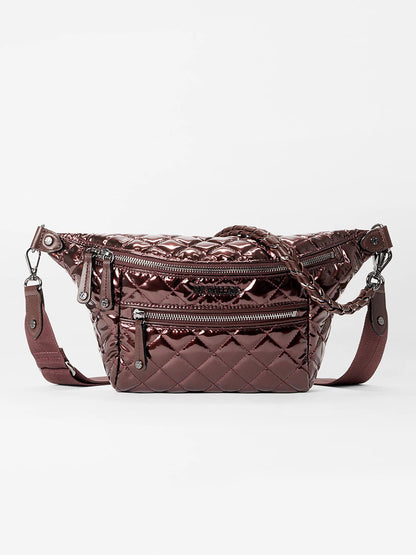 The MZ Wallace Small Crosby Sling Bag in Bordeaux Lacquer Oxford is a quilted metallic crossbody with zippered compartments and an adjustable strap, shown against a plain white background.
