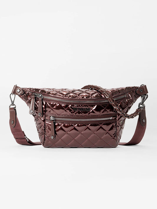 The MZ Wallace Small Crosby Sling Bag in Bordeaux Lacquer Oxford is a quilted metallic crossbody with zippered compartments and an adjustable strap, shown against a plain white background.