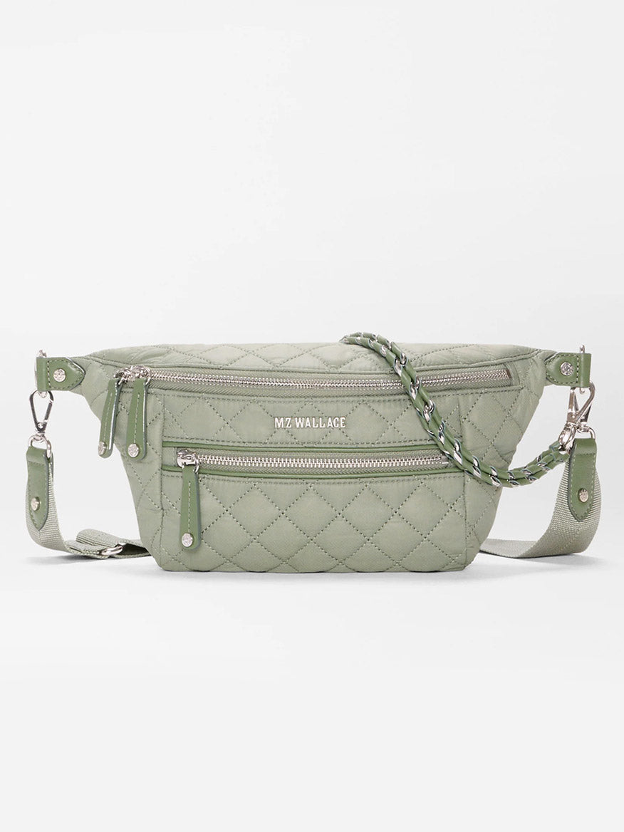 The MZ Wallace Small Crosby Sling Bag in Agave Green Oxford features a quilted design, silver zippers, detachable strap, braided handle, and front logo.