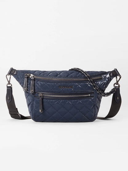 The MZ Wallace Small Crosby Sling Bag in Ink Liquid Oxford is a quilted crossbody with multiple zippered compartments and a detachable black strap, shown against a plain white background.