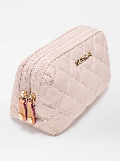 The MZ Wallace Small Double Zip Cosmetic in City Pink Oxford is a quilted light pink pouch made from REC Oxford Fabrication, with gold-tone hardware, double zip top closure, and "THE SMALL ONE" embossed in gold letters.