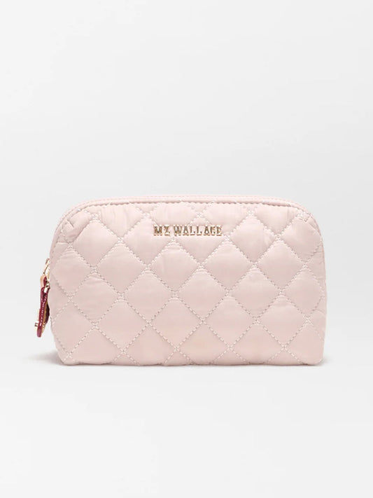 The MZ Wallace Small Double Zip Cosmetic in City Pink Oxford is a light pink quilted pouch with a zip top and gold logo, made from REC Oxford Fabrication, shown against a plain white background.