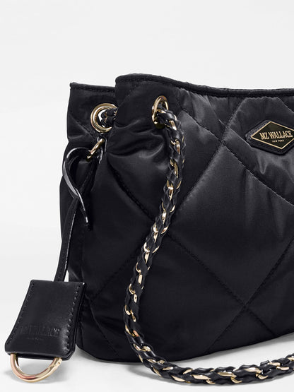 The MZ Wallace Small Frankie Tote in Black Bedford is a black quilted nylon bag with gold and black chain straps, a metal ring detail, an adjustable crossbody strap, and a prominent “MZ Wallace” logo patch on the front.