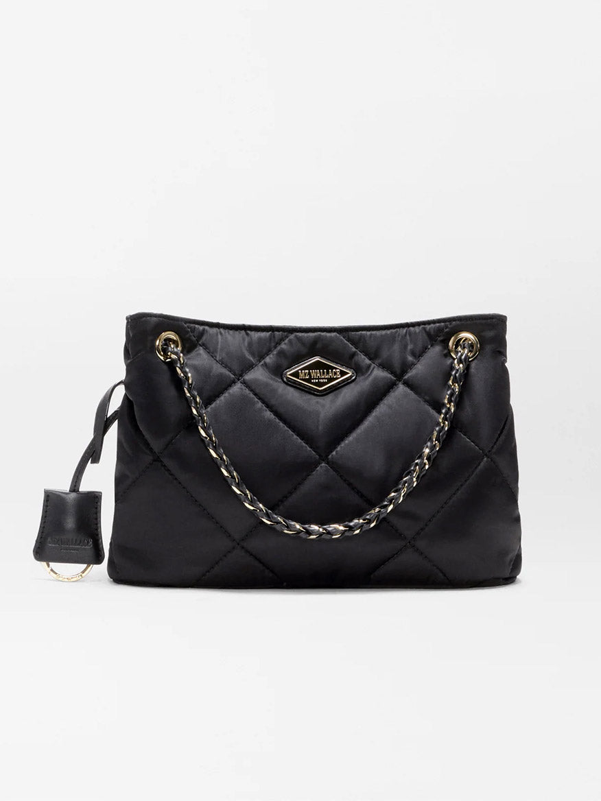 MZ Wallace Small Frankie Tote in Black Bedford, featuring quilted nylon, gold chain handles, a gold logo plate, and a small attached case on the left side, comes with an adjustable crossbody strap—displayed against a plain white background.