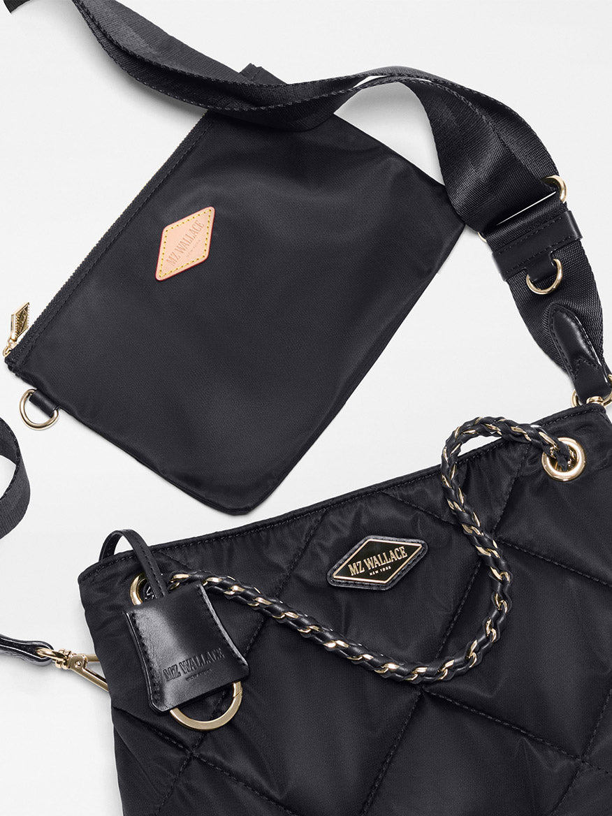 Two black bags with gold accents are displayed; one is the MZ Wallace Small Frankie Tote in Black Bedford, featuring quilted nylon, chain straps, an adjustable crossbody strap, and a leather tag, while the other is a flat pouch—perfect as a small black tote—with a zipper and a small tan patch.