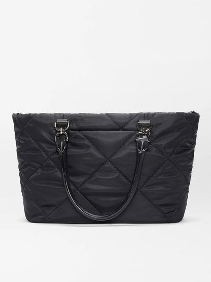 The MZ Wallace Small Madison E/W Tote in Black Bedford features a black quilted design, double handles, Italian leather trim, and metal hardware in a slim east-west silhouette against a plain white background.