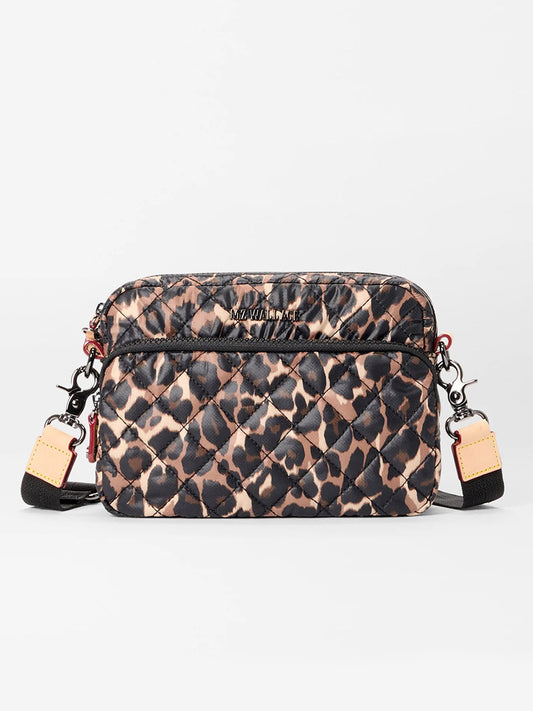 The MZ Wallace Small Metro Camera Bag in Leopard Oxford features a quilted nylon design, leopard print, front zip pocket, and beige leather strap accents—offering the stylish look of the classic Metro Crossbody.