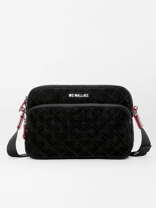 MZ Wallace Small Metro Camera Bag in Black Velvet Finish, a small black quilted crossbody with a front zip pocket and an adjustable strap featuring red accents.