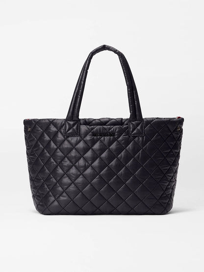 The MZ Wallace Small Metro City Tote in Black Oxford features a quilted exterior and two handles, shown against a plain white background.