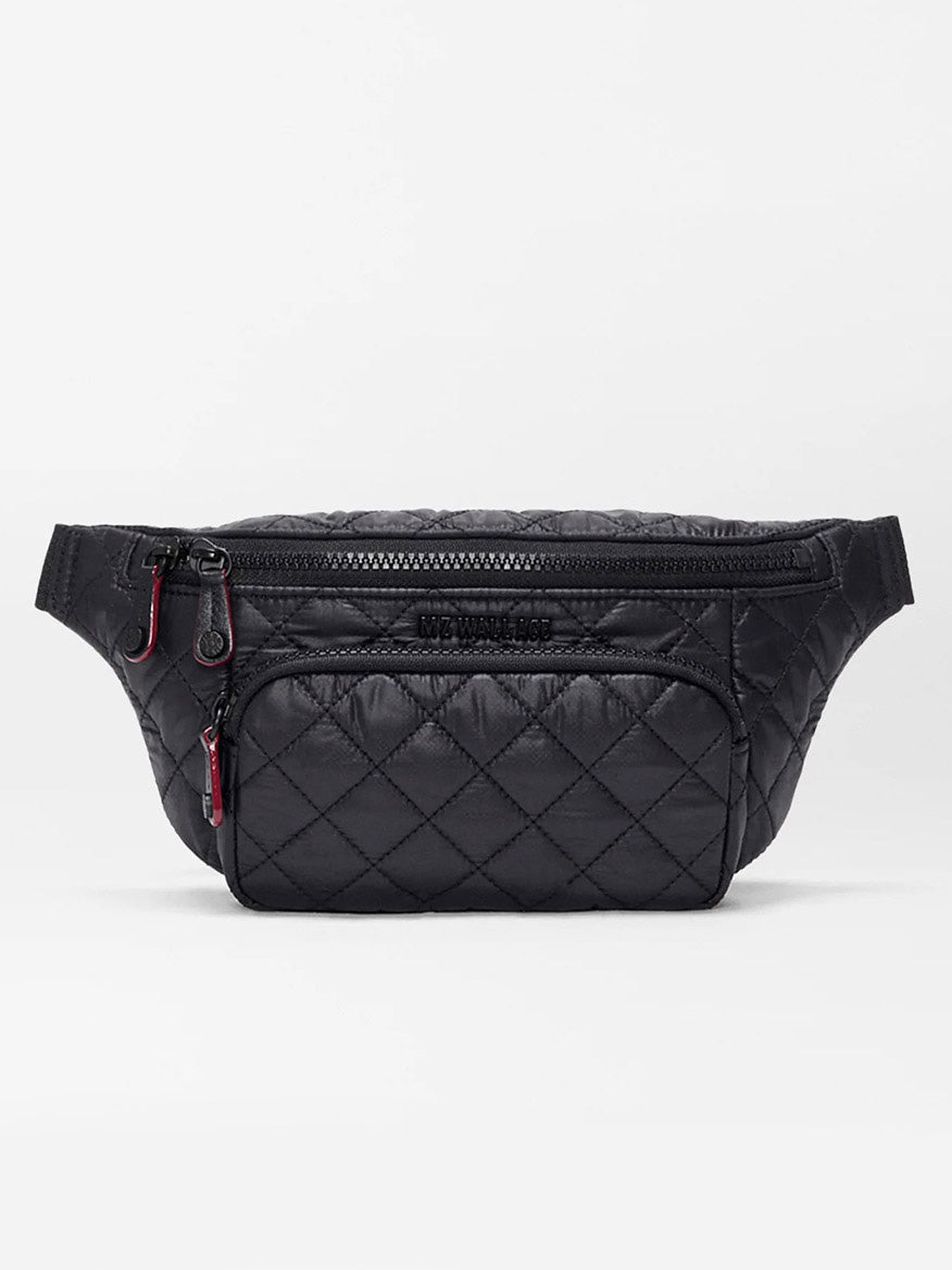 The MZ Wallace Small Metro Sling in Black Oxford features a black quilted design, Italian leather trim, two zippered compartments, and subtle stitching, shown against a plain white background.