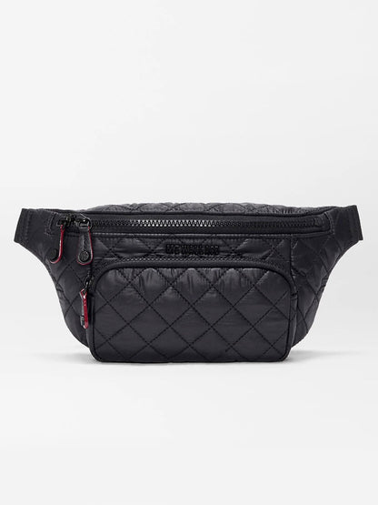 The MZ Wallace Small Metro Sling in Black Oxford features a black quilted design, Italian leather trim, two zippered compartments, and subtle stitching, shown against a plain white background.