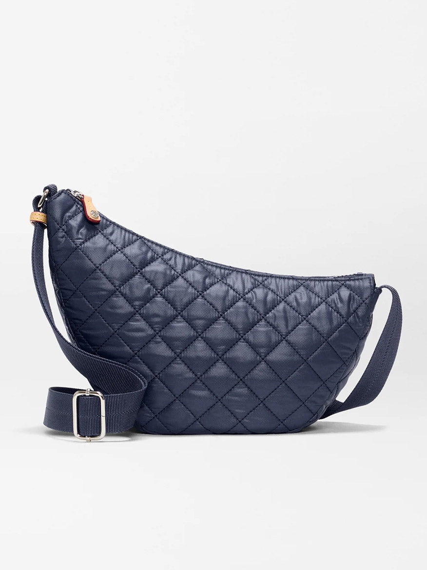 The MZ Wallace Small Metro Smile Bag in Dawn Oxford features a navy quilted design with Italian leather trim, adjustable nylon strap, and zipper closure, shown against a plain light background.