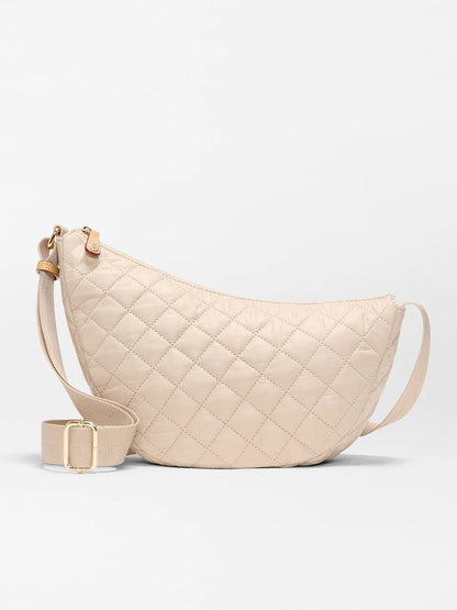 The MZ Wallace Small Metro Smile Bag in Buff Oxford features Italian leather trim, an adjustable nylon strap, and gold-tone hardware, displayed against a plain light background.