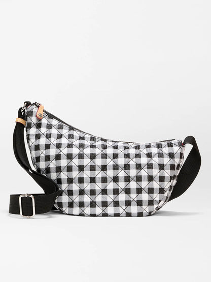 The MZ Wallace Small Metro Smile Bag in Black/White Gingham Oxford features a quilted gingham pattern, black adjustable nylon strap, Italian leather trim, and zipper closure.
