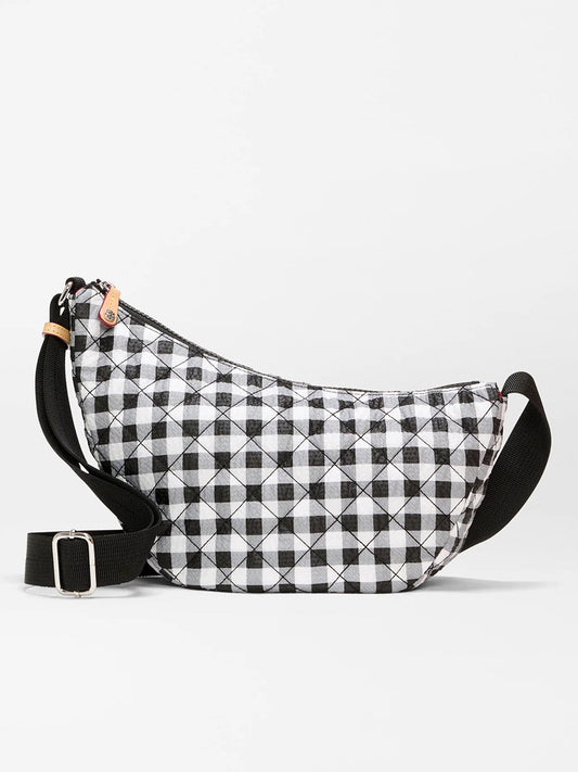The MZ Wallace Small Metro Smile Bag in Black/White Gingham Oxford features a quilted gingham pattern, black adjustable nylon strap, Italian leather trim, and zipper closure.