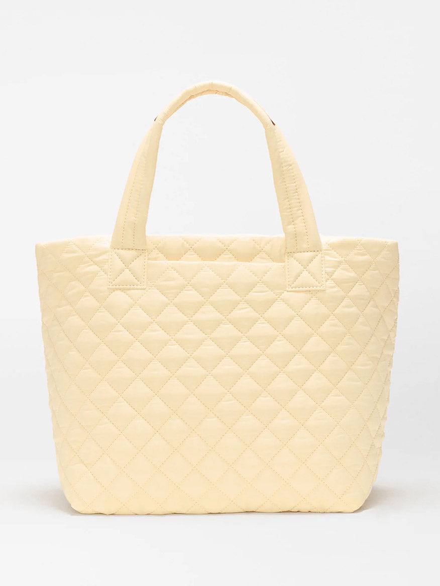 The MZ Wallace Small Metro Tote Deluxe in Chamomile Oxford features a cream quilted design with Italian leather trim and two short handles, shown against a plain white background.