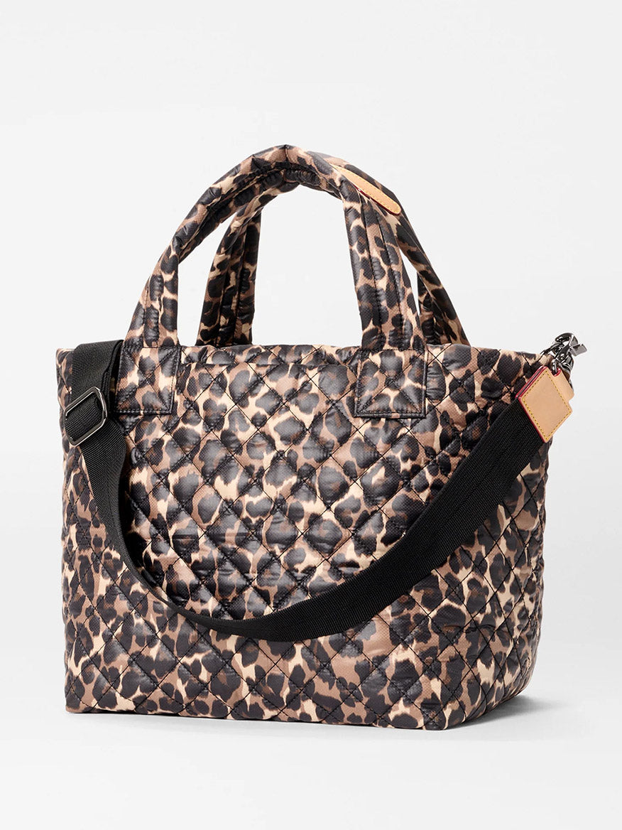 The MZ Wallace Small Metro Tote Deluxe in Leopard Oxford features a brown and black leopard print, short handles, a black adjustable crossbody strap, and elegant Italian leather trim.