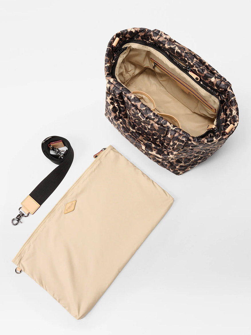 The MZ Wallace Small Metro Tote Deluxe in Leopard Oxford features Italian leather trim, a beige interior, a detachable black crossbody strap, and a separate beige pouch—all displayed on a white surface.
