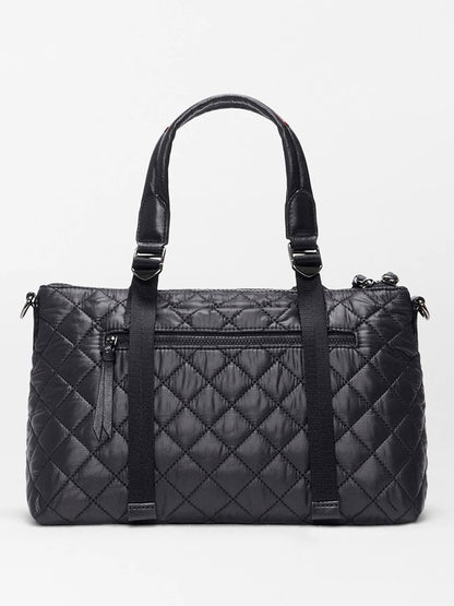 The MZ Wallace Small Park Satchel in Black Oxford features a quilted design, double handles, front zip pocket, and vertical strap details, shown against a plain light background.