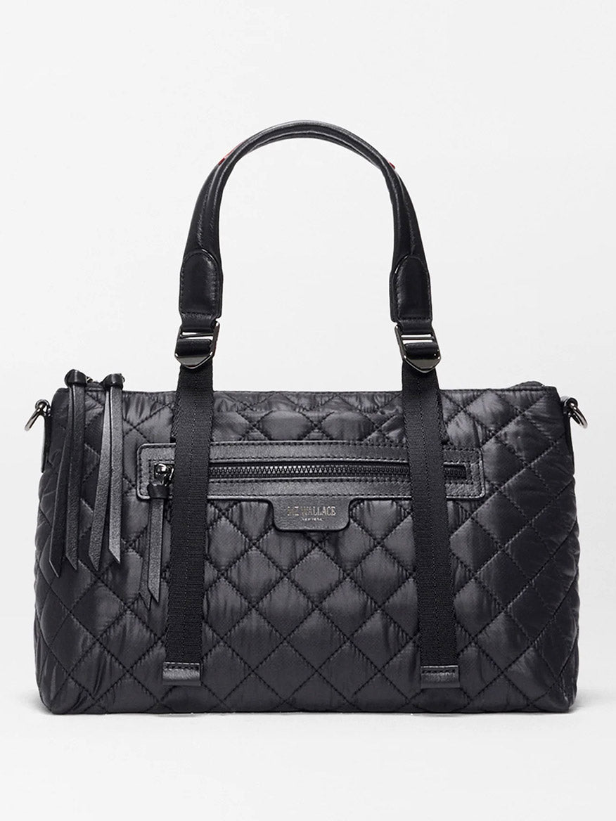 The MZ Wallace Small Park Satchel in Black Oxford features a compact black quilted design, two handles, a front zip pocket, decorative tassels, and a subtle brand label—perfect as an everyday bag.