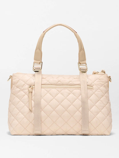 MZ Wallace Small Park Satchel in Buff Oxford: a quilted bag with gold hardware, dual top handles, front zip pocket, and vertical strap accents—ideal for daily use.