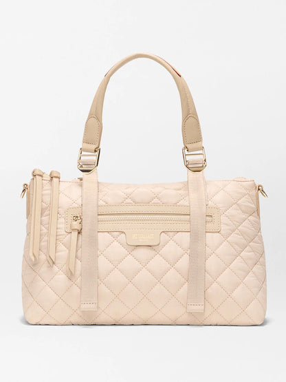 The MZ Wallace Small Park Satchel in Buff Oxford offers effortless style with beige quilted design, two handles, gold hardware, a front zipper pocket, and a subtle logo—making it the perfect everyday satchel.