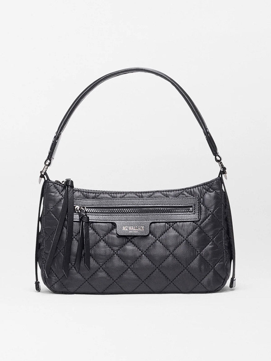 The MZ Wallace Small Park Shoulder Bag in Black Oxford features quilted Italian leather, a top handle, front zipper pocket, and tassel accents. This lightweight bag is shown against a plain white background.
