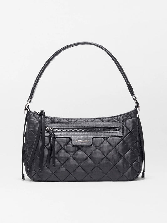 The MZ Wallace Small Park Shoulder Bag in Black Oxford features quilted Italian leather, a top handle, front zipper pocket, and tassel accents. This lightweight bag is shown against a plain white background.