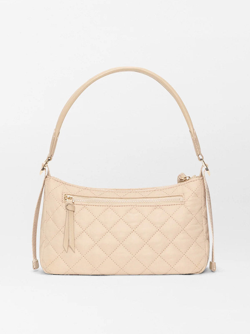 The MZ Wallace Small Park Shoulder Bag in Buff Oxford features a beige quilted design, single strap, front zipper pocket, and lightweight construction—perfect for effortless style against a white background.