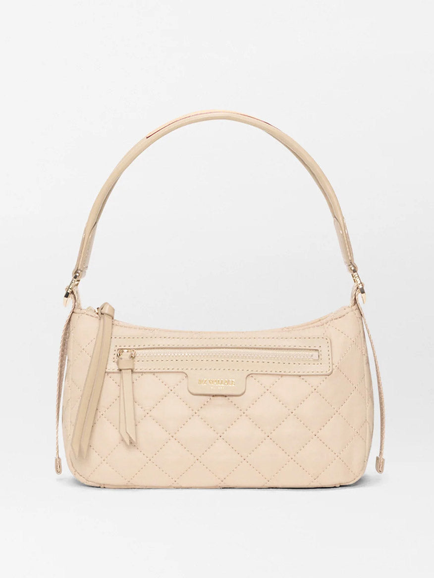 The MZ Wallace Small Park Shoulder Bag in Buff Oxford is a beige quilted purse with a curved strap, front zipper pocket, and gold-toned hardware, shown on a plain white background.