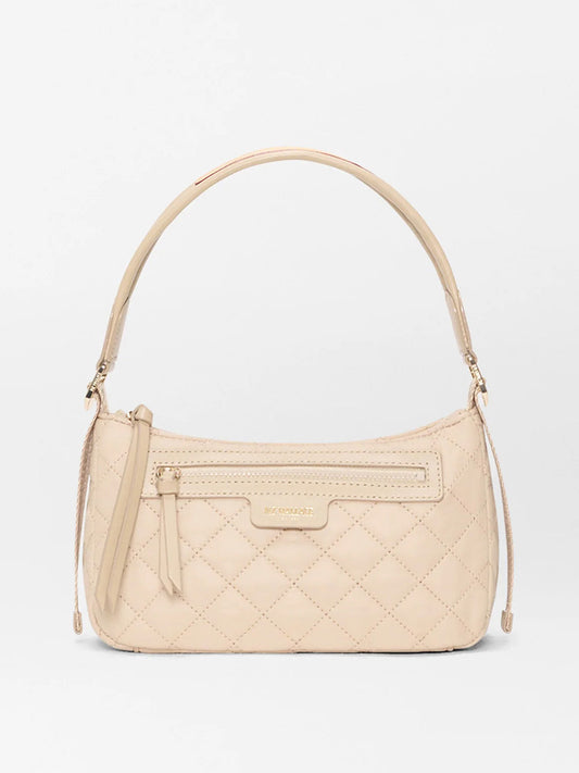 The MZ Wallace Small Park Shoulder Bag in Buff Oxford is a beige quilted purse with a curved strap, front zipper pocket, and gold-toned hardware, shown on a plain white background.