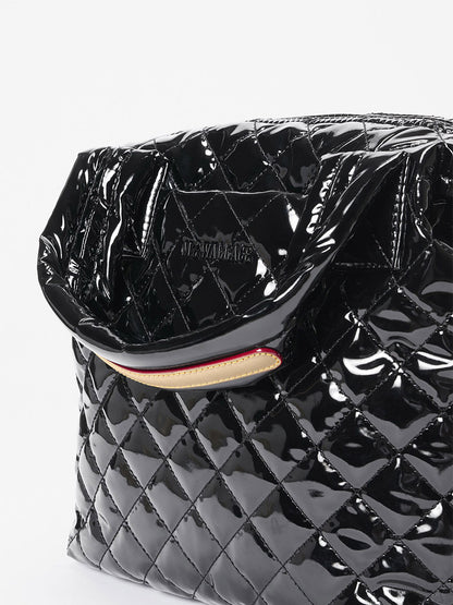 Close-up of the MZ Wallace Small Sutton Deluxe in Black Lacquer Oxford, featuring Italian leather trim, glossy black quilted finish, partially open top, and visible stitching detail.