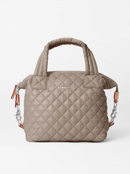 The MZ Wallace Small Sutton Deluxe in Morning Dove Oxford is a quilted taupe crossbody bag with dual top handles, a detachable chain strap, zip closure, and "MZ WALLACE" in silver letters on the front.
