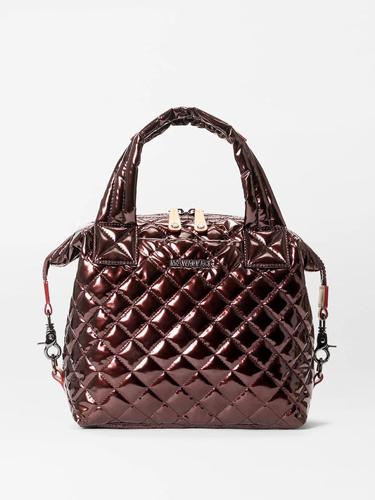 The MZ Wallace Small Sutton Deluxe in Bordeaux Lacquer Oxford features a metallic quilted finish, Italian leather trim, short handles, detachable crossbody strap, and gold-tone hardware, shown against a plain white background.