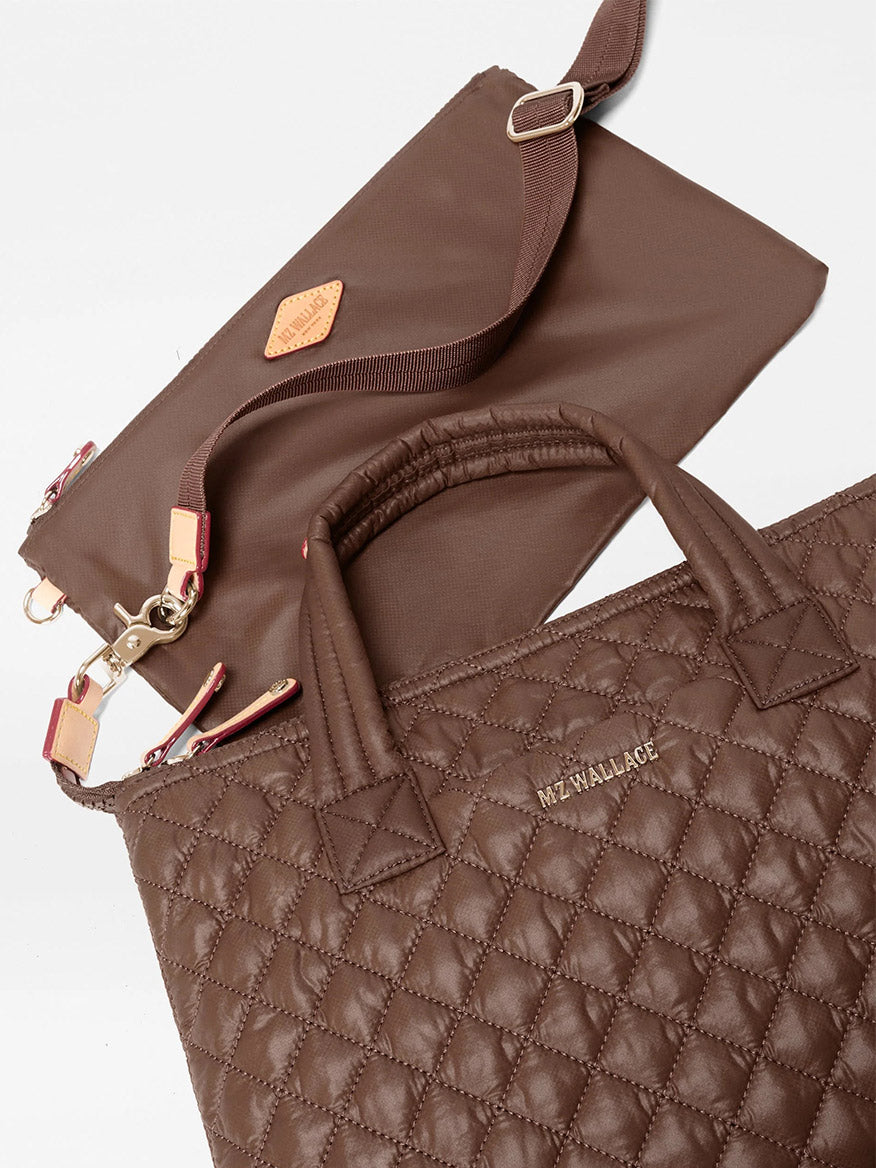 Two brown quilted recycled Oxford nylon handbags with gold hardware, including the MZ Wallace Small Sutton Deluxe in Walnut Oxford featuring top handles and a crossbody bag with a detachable shoulder strap, displayed on a white background.