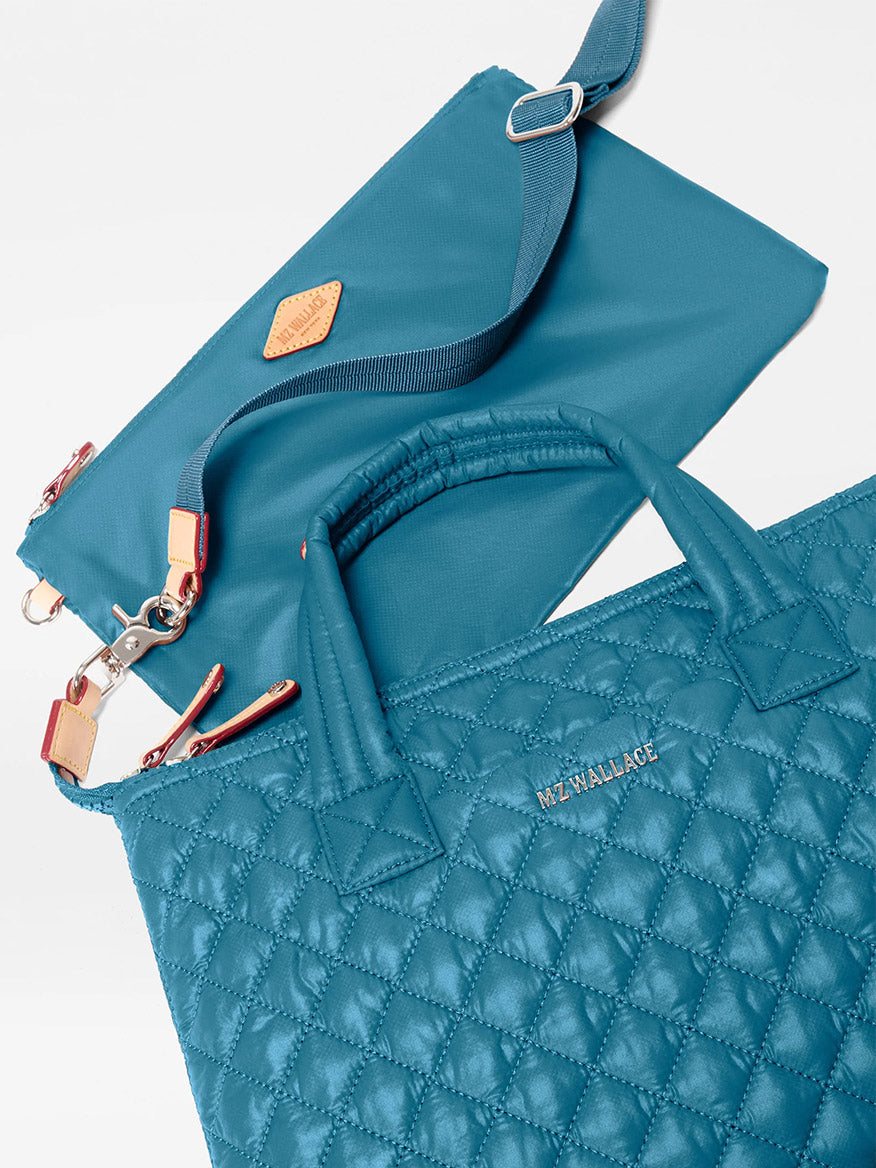 The MZ Wallace Small Sutton Deluxe in Pacific Oxford, a teal quilted nylon bag with an adjustable crossbody strap and matching pouch, shown on a white background.