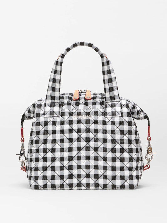 The MZ Wallace Small Sutton Deluxe in Black/White Gingham Oxford features a quilted black-and-white gingham design, Italian leather trim, two handles, metal clasps, and an adjustable crossbody strap for versatile styling.