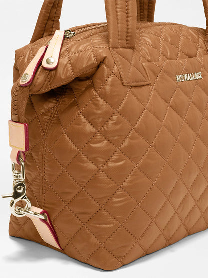 MZ Wallace Small Sutton Deluxe in Cognac Oxford, a quilted brown recycled nylon handbag with light-colored leather trim and gold-tone hardware.