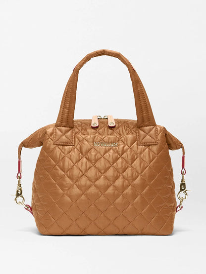 Small tan quilted MZ Wallace Small Sutton Deluxe in Cognac Oxford handbag with top handles, two zipper pulls, and detachable shoulder strap clips on the sides.