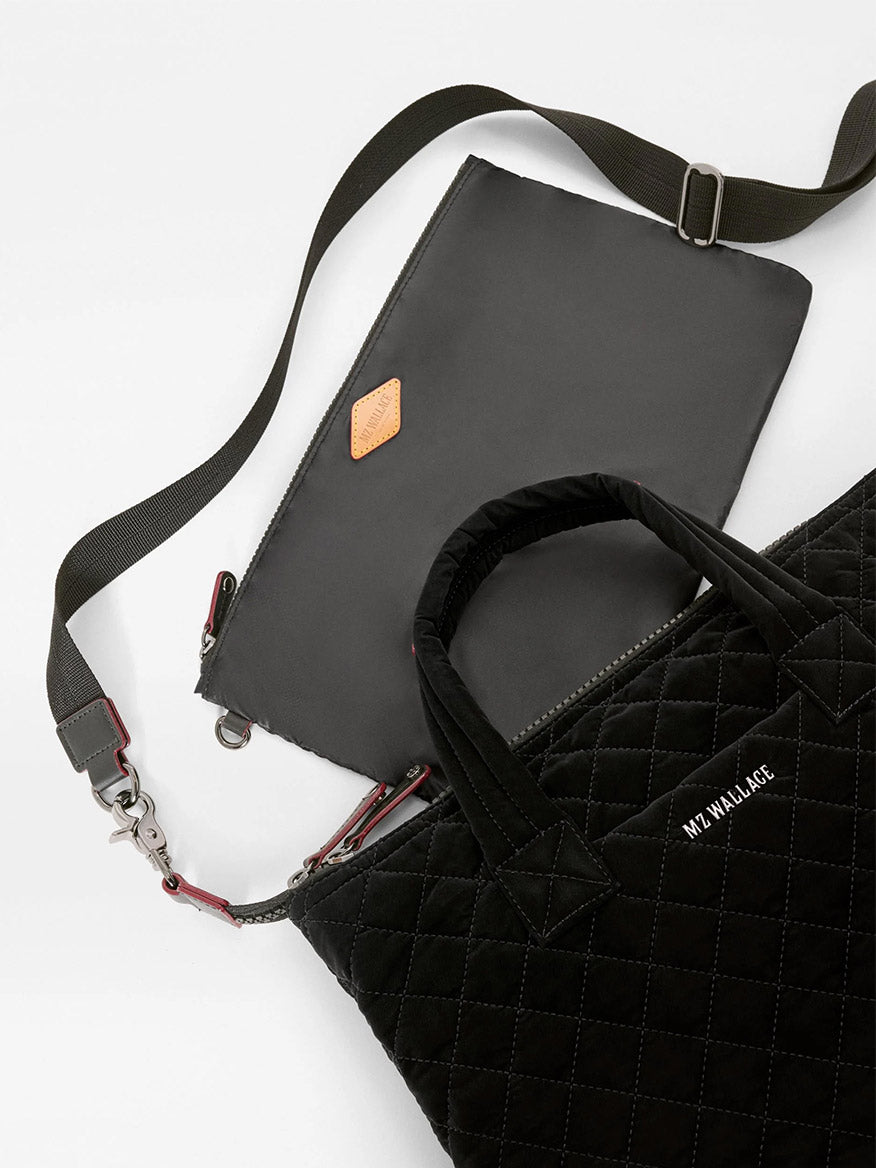 A black quilted MZ Wallace Small Sutton Deluxe in Black Velvet Finish tote with top handles and a matching detachable pouch with a crossbody strap.